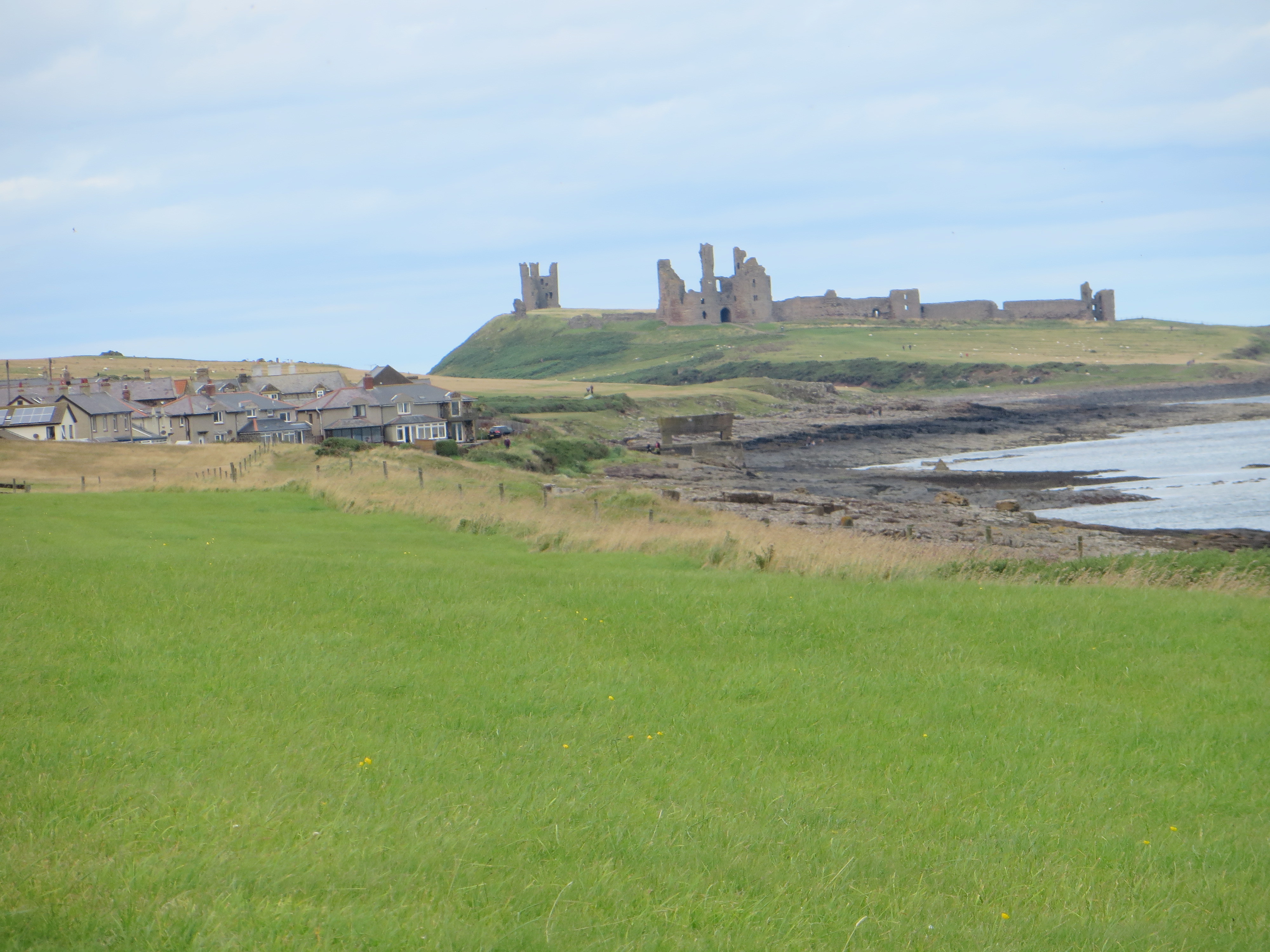Ruins of castle on hill by sea Northumberland