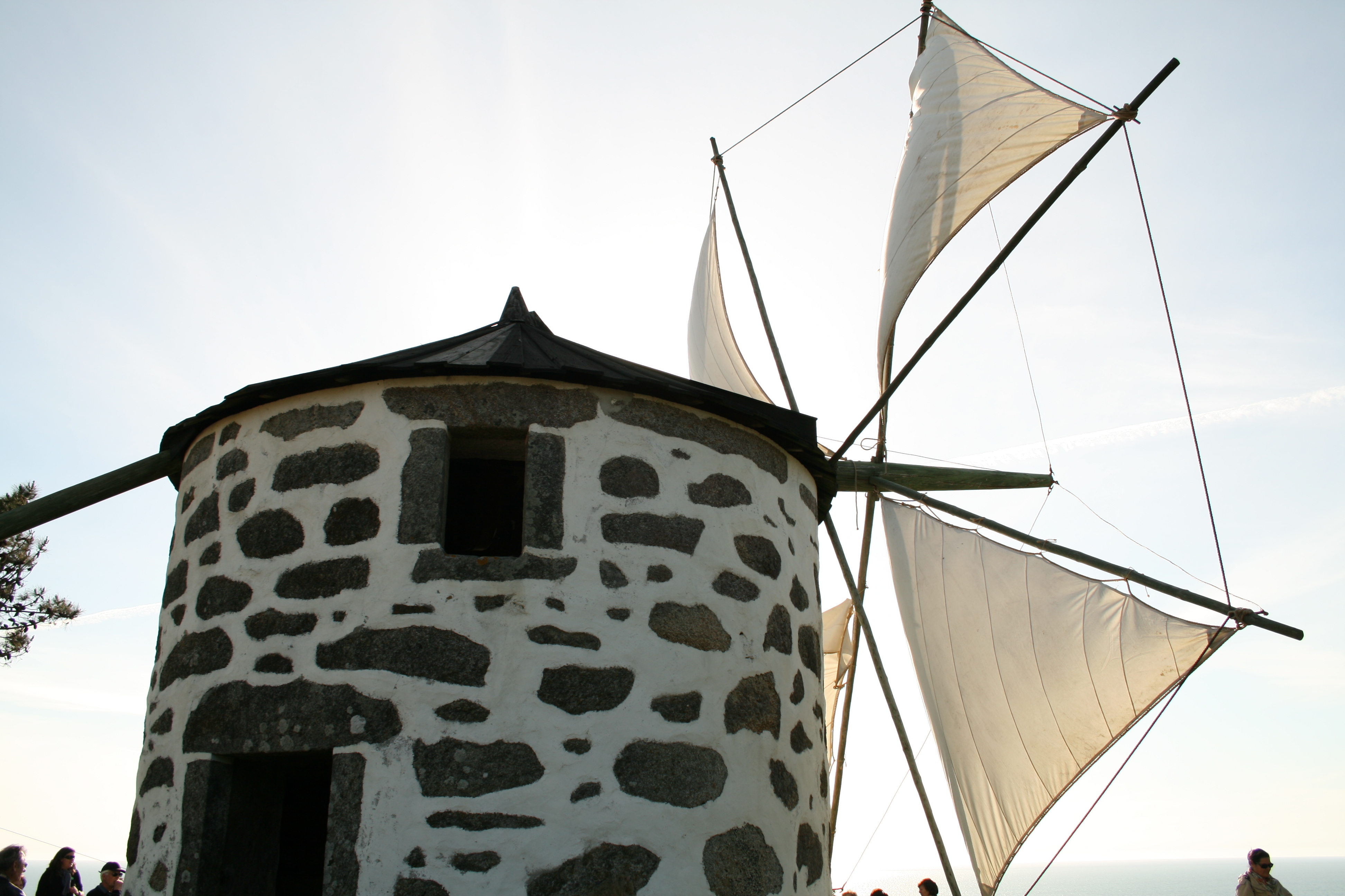 Stone windmill with white sails