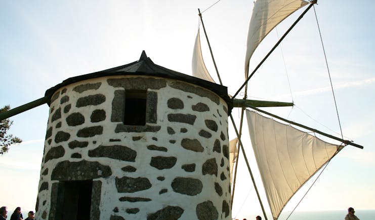 Stone windmill with white sails