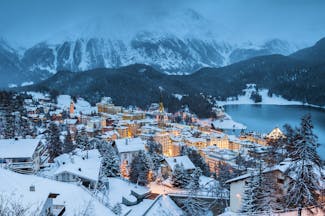 Dusk winter view of St Moritz town, lake and mountains