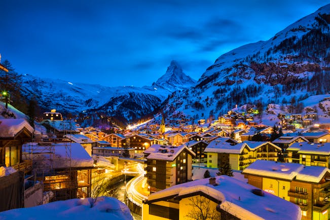Winter evening scene with lights of Zermatt with Matterhorn in distance