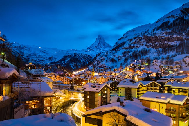 Winter evening scene with lights of Zermatt with Matterhorn in distance