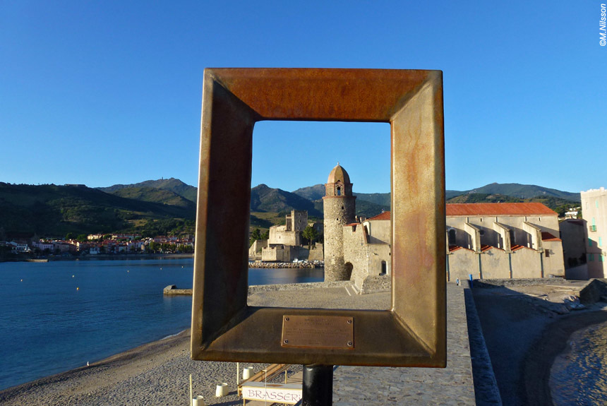 Frame of painting masking church tower on beach