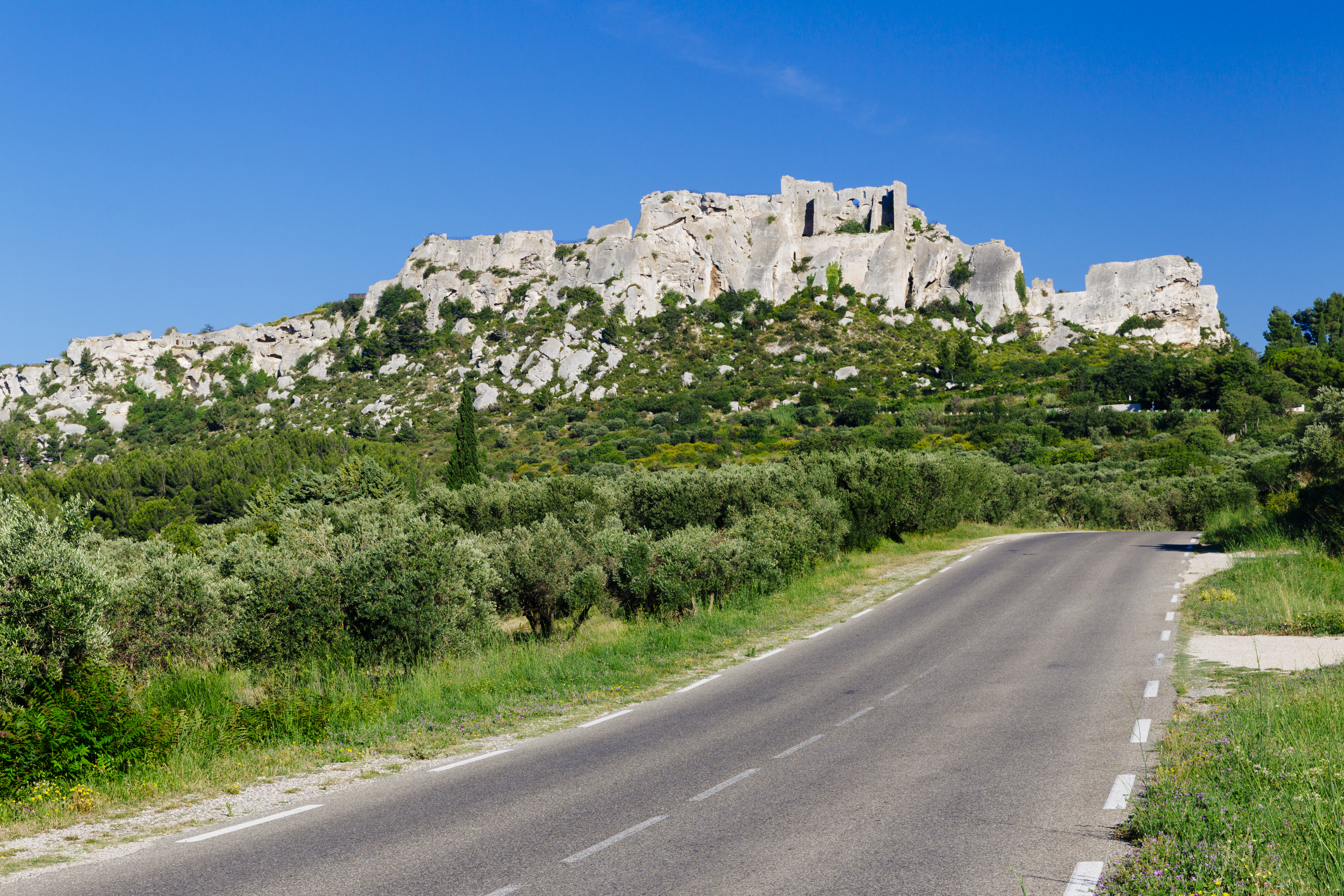 Hill town of Les Baux de Provence with road in foreground