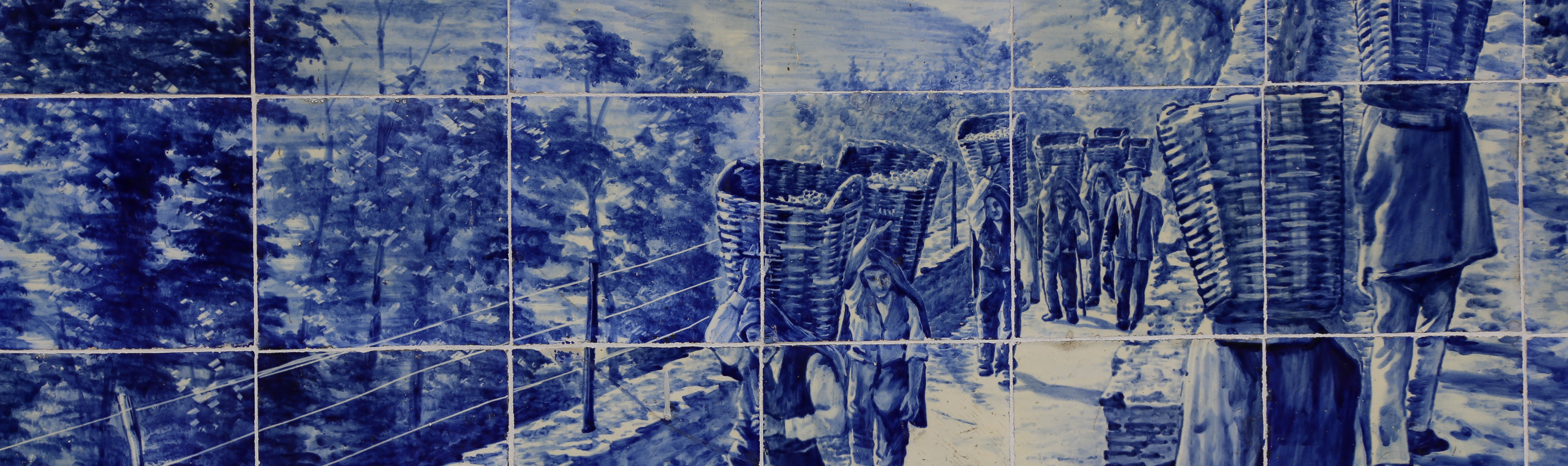 Blue ceramic tiles of vineyard workers carrying baskets of grapes